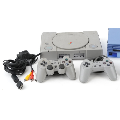 2068 - Two Sony PlayStation 1 games consoles with controllers, a Sony PlayStation 2 and a collection of Pla... 