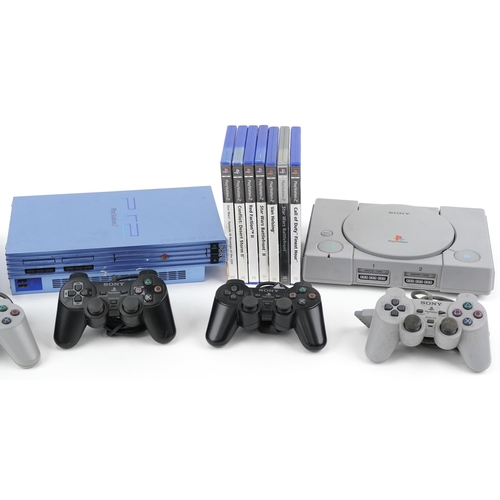 2068 - Two Sony PlayStation 1 games consoles with controllers, a Sony PlayStation 2 and a collection of Pla... 