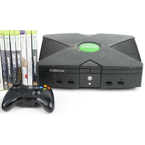 2073 - Two Xbox games consoles with two Xbox controllers and a collection of Xbox 360 games