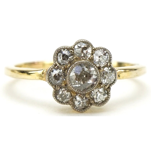 3077 - Unmarked gold diamond flower head ring, the central diamond approximately 0.16 carat, size K, 2.5g