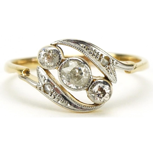 3051 - 18ct gold and platinum diamond crossover ring, the central diamond approximately 3.40mm in diameter ... 