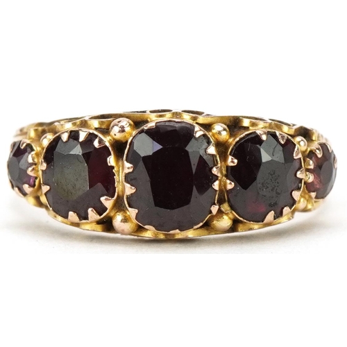 3256 - Antique 9ct gold graduated garnet five stone ring with ornate setting and engraved band, indistinct ... 