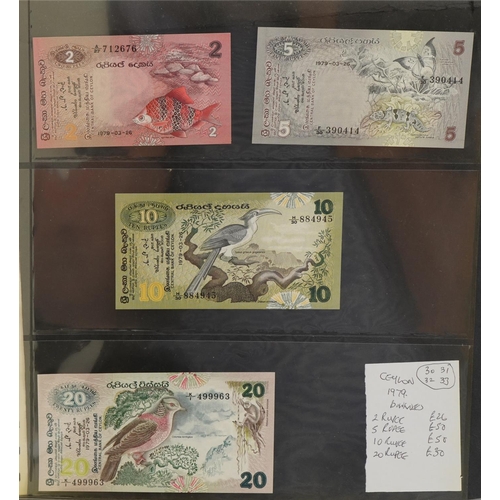 2252 - Green album containing vintage banknotes to include Seychelles 1983 twenty five rupees, China Sun Ya... 