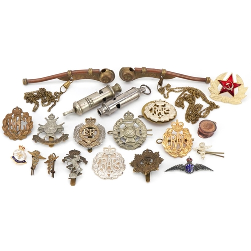 2528 - Military interest cap badges and whistles including a silver and enamel RAF sweetheart brooch and na... 