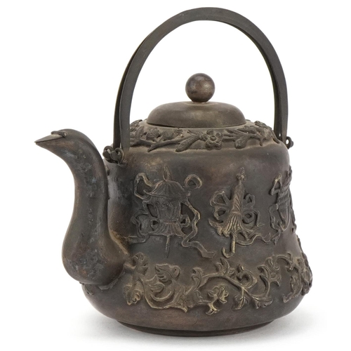 1148 - Chinese white metal teapot decorated in relief with foliage and objects, with box, 9.5cm high