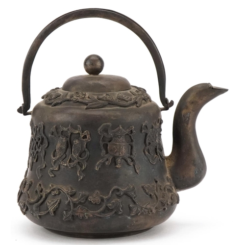 1148 - Chinese white metal teapot decorated in relief with foliage and objects, with box, 9.5cm high