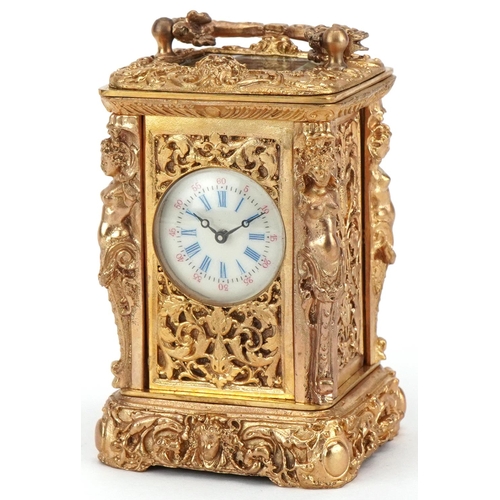 231 - Miniature gilt brass Rococo style carriage clock having enamelled dial with Roman numerals and a swi... 