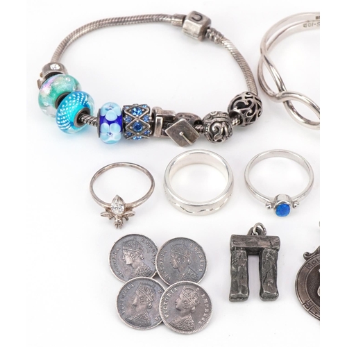 3165 - Silver and white metal jewellery including two charm bracelets, silver ingot pendant, sports jewel, ... 