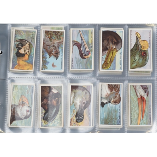 2296 - Nine albums of cigarette cards to include Player's Natural History set of fifty, Ogden's Zoo Studies... 