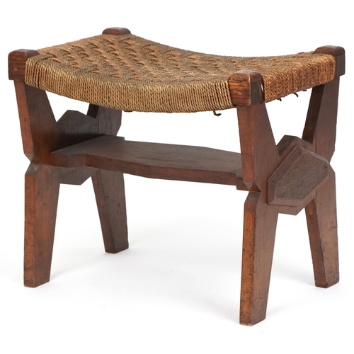 1029 - Early 20th century Arts & Crafts oak stool, the woven string seat raised on shaped supports, 40cm H ... 