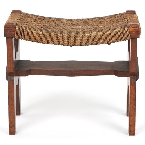 1029 - Early 20th century Arts & Crafts oak stool, the woven string seat raised on shaped supports, 40cm H ... 