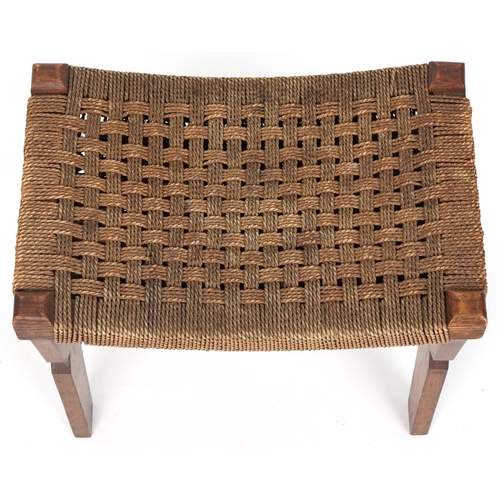 1029 - Early 20th century Arts & Crafts oak stool, the woven string seat raised on shaped supports, 40cm H ... 