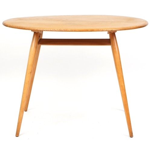 1002 - Ercol elm oval breakfast table raised on four tapering legs united by a newspaper rack, 73cm H x 99c... 