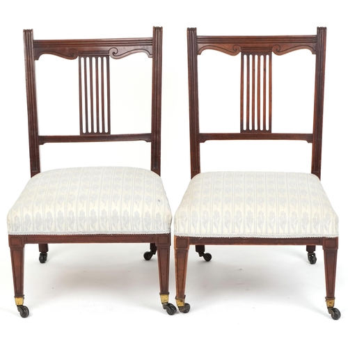 1083 - Pair of Edwardian mahogany nursing chairs with over stuffed seats, raised on tapering legs and caste... 