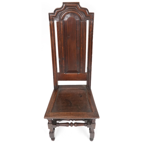 1070 - 18th century oak panel back hall chair with solid seat raised on turned and block legs united by str... 