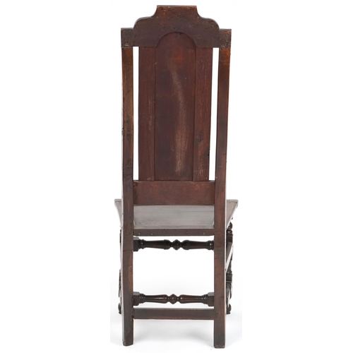 1070 - 18th century oak panel back hall chair with solid seat raised on turned and block legs united by str... 