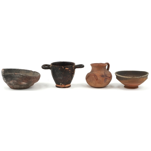 355 - Group of four Greek pottery items including footed bowl, jug, two handled cup and a pouring vessel, ... 