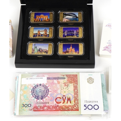 2244 - Quantity of world banknotes in mint condition, many in bundles and a set of six gold plated ingots i... 