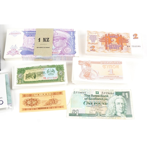 2244 - Quantity of world banknotes in mint condition, many in bundles and a set of six gold plated ingots i... 