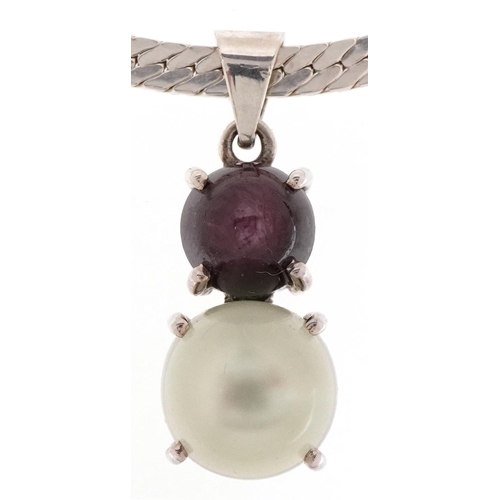 3163 - Unmarked silver cabochon moonstone and star ruby pendant on a silver necklace, 3.2cm high and 40cm i... 