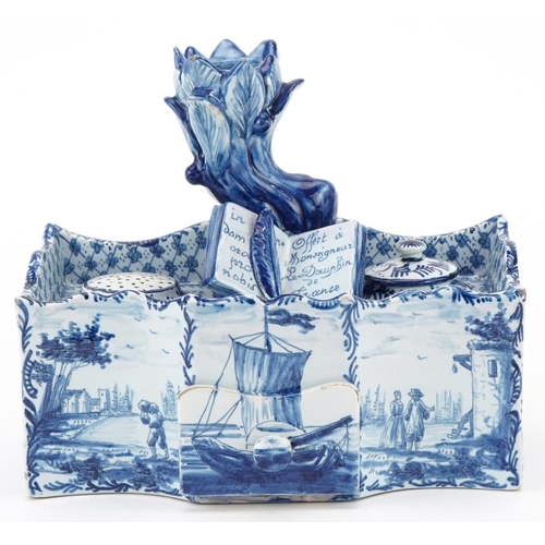 304 - Dutch Delft blue and white faience double inkwell, 19th century, the naturalistic top fitted with a ... 