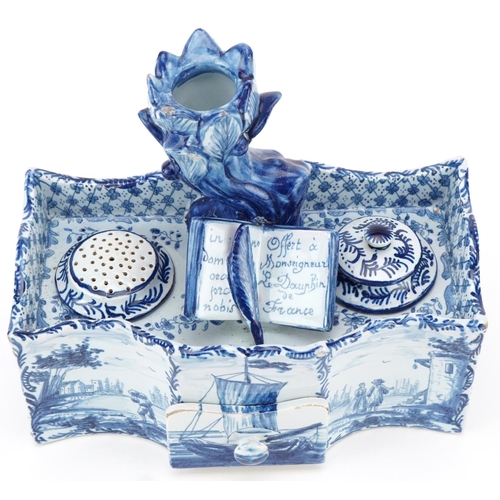 304 - Dutch Delft blue and white faience double inkwell, 19th century, the naturalistic top fitted with a ... 