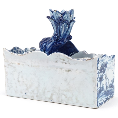 304 - Dutch Delft blue and white faience double inkwell, 19th century, the naturalistic top fitted with a ... 