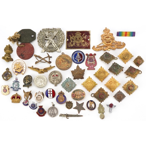 2529 - Small group of various military cap badges, buttons and pins