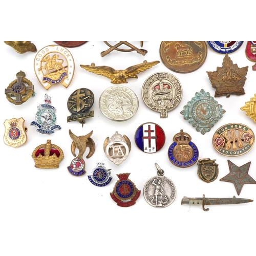 2529 - Small group of various military cap badges, buttons and pins