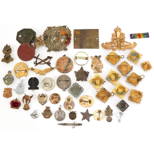 2529 - Small group of various military cap badges, buttons and pins