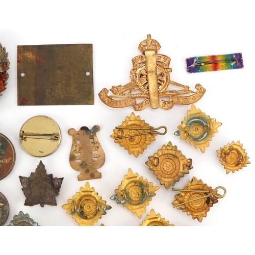 2529 - Small group of various military cap badges, buttons and pins