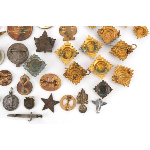 2529 - Small group of various military cap badges, buttons and pins