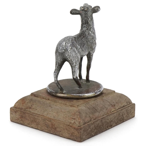 2456 - Early to mid 20th century cast metal car mascot in the form of a goat, mounted on a later wooden bas... 