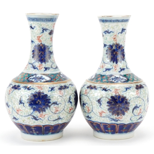 213 - Pair of Chinese porcelain enamelled pear shaped vases, Kangxi marks but probably later, each bearing... 