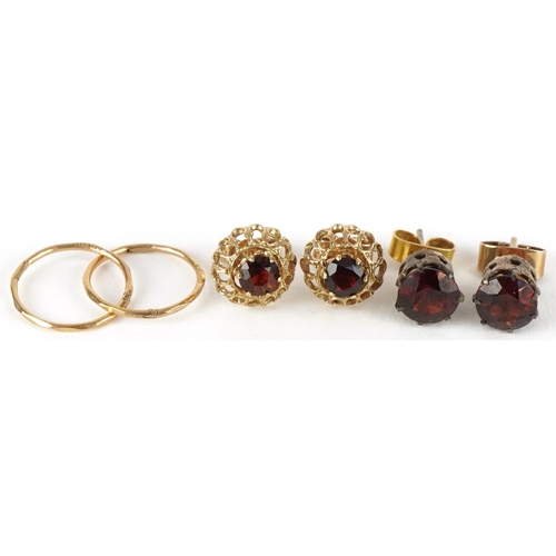 3269 - Two pairs of 9ct gold earrings and a pair of yellow metal earrings, two pairs set with garnet solita... 