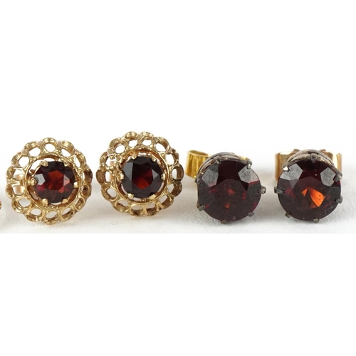 3269 - Two pairs of 9ct gold earrings and a pair of yellow metal earrings, two pairs set with garnet solita... 