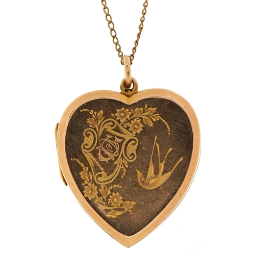 3201 - Victorian 15ct gold love heart locket engraved with a bird amongst flowers on a yellow metal necklac... 