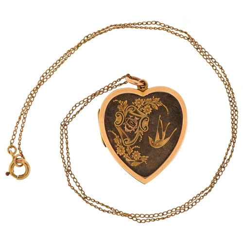 3201 - Victorian 15ct gold love heart locket engraved with a bird amongst flowers on a yellow metal necklac... 