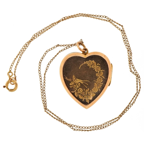 3201 - Victorian 15ct gold love heart locket engraved with a bird amongst flowers on a yellow metal necklac... 