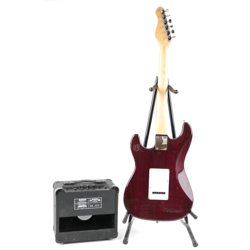 617 - Encore Stratocaster six string electric guitar in red together with a Kuston practice amplifier