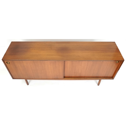 1058 - Mid 20th century teak sideboard, the sliding doors revealing sliding trays to one end, raised on tur... 