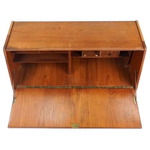 1057 - Mid to late 20th century teak bureau, the fall flap above two drawers and a cupboard on tapering leg... 