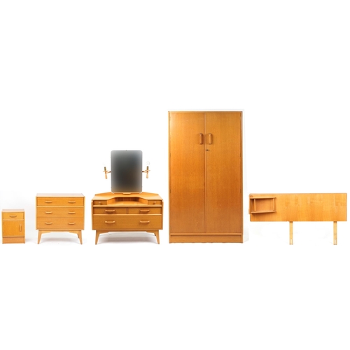 1004 - Mid 20th century G Plan golden oak bedroom suite comprising dressing table, chest of drawers, bedsid... 