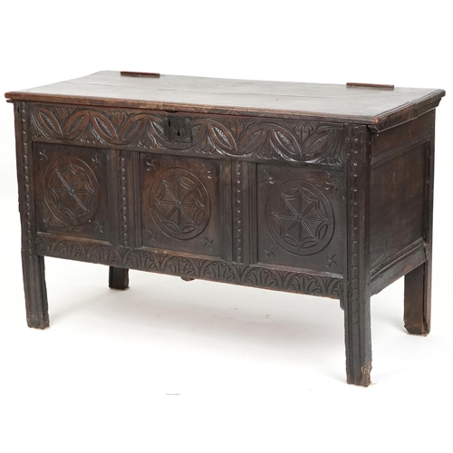 1014 - 18th century oak coffer with later carved decoration, the hinged lid raised on stile supports, 78cm ... 