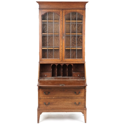 1062 - Edwardian oak bureau bookcase fitted with a pair of leaded glazed doors, the fall front above three ... 