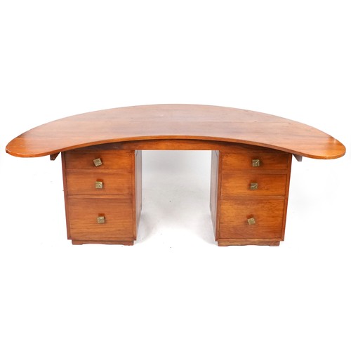 1003 - Large designer mid 20th century exotic wood twin pedestal desk on stylish plinth bases, the shaped t... 