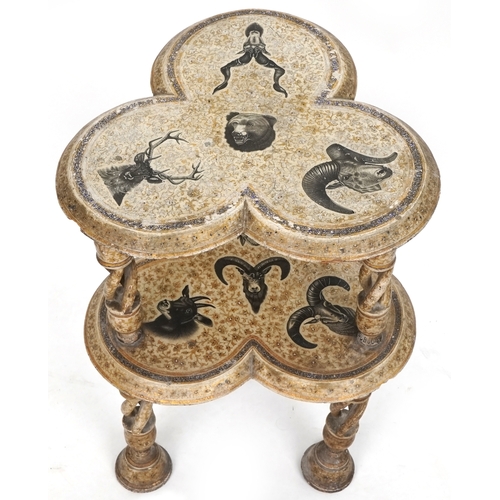 1006 - A late 19th/early 20th Kashmiri lacquered two tier lamp table decorated with animal heads, raised on... 