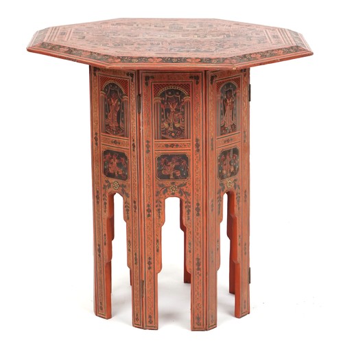 1021 - Late 19th century Burmese red lacquer octagonal folding table, the top profusely decorated with figu... 