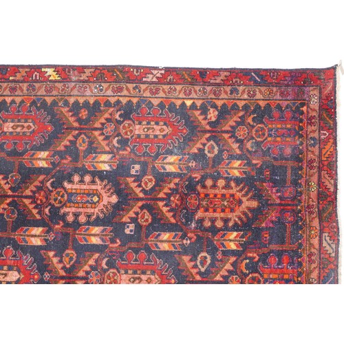 1018 - Hamadan rug, North West Persia, early 20th century, the dark blue field with three rows of shaped me... 