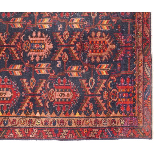 1018 - Hamadan rug, North West Persia, early 20th century, the dark blue field with three rows of shaped me... 